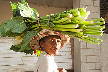 Woman Carrying Calla Lilies On Her Head In Fianarantsoa, Madagascar