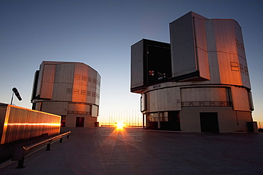 Sun Unit Telescope 1 & Moon Unit Telescope 2, Belonging To The Very Large Telescope (Vlt) Operated By The European Southern Observatory On Cerro Paranal At Sunset, Antofagasta Region, Chile