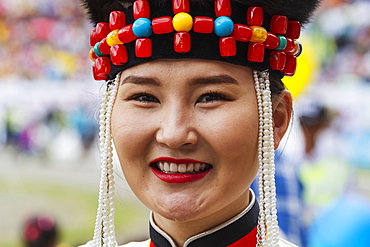 Woman in traditional Buryat dress at the 2014 Naadam Mongolian National Festival celebration by the National Sports Stadium, Ulaanbaatar (Ulan Bator), Mongolia