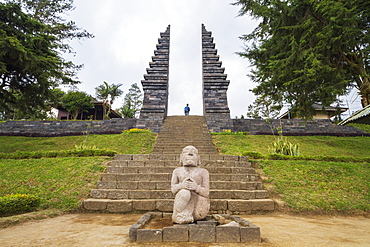 Stone statue and ceremonial gate of Candi Cetho, a Javanese-Hindu temple located on the western slope of Mount Lawu, Central Java, Indonesia