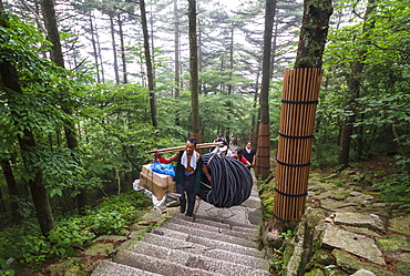 Porter carrying items, Mount Huangshan, Anhui, China