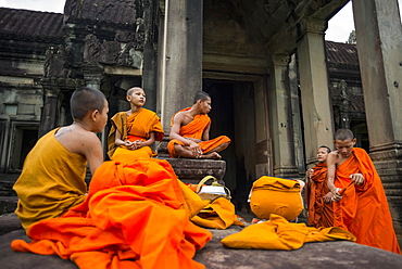 A group of young monks hang out at Angkor Wat, Siem Reap, Cambodia