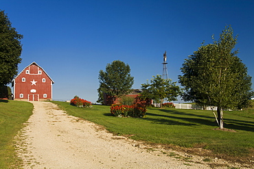 Red barn and windmill at a farm, near Edgewood, Iowa, United States of America