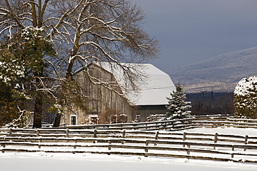 Barn roof and farmyard covered with snow in winter, Bromont, Quebec, Canada