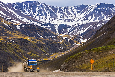 A semi-truck ascends through Atigun Pass along the Dalton Highway; Alaska, United States of America