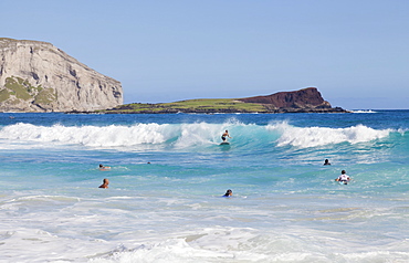 Bodyboarders catching waves at Makapu'u Beach; Waimanalo, Oahu, Hawaii, United States of America