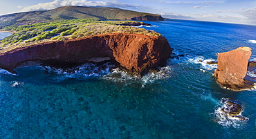 An aerial view of Puu Pehe Rock at sunset, also known as 'Sweetheart Rock', one of Lanai's most recognizable landmarks, Lanai, Hawaii, United States of America