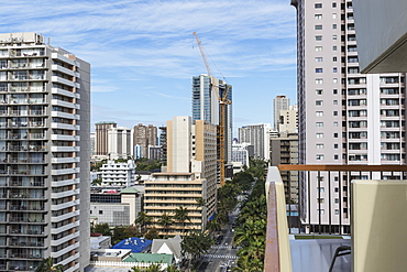 Westward view down Kuhio Avenue from a hotel balcony in Waikiki, Honolulu, Oahu, Hawaii, United States of America