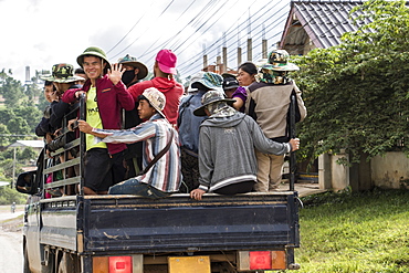 People riding in the back of a truck, Phonsavan, Xiangkhouang, Laos