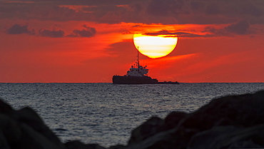 Tugboat in sunset viewed from Magic Island, Ala Monana beach park, Honolulu, Oahu, Hawaii, United States of America