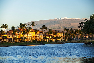 Condominiums and a view of the snow-capped Mauna Kea from the King's Shops at Waikoloa Resort, Island of Hawaii, Hawaii, United States of America