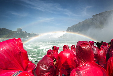 Tourists on a boat wearing red ponchos and viewing Niagara Falls, Niagara Fall, Ontario, Canada