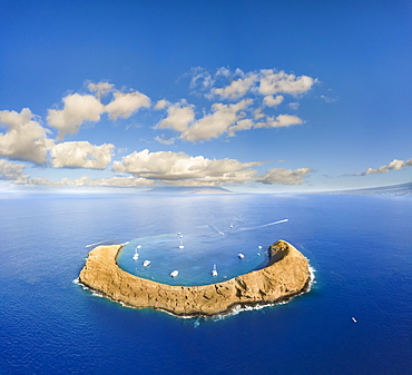 Molokini Crater, aerial shot of the crescent shaped islet at mid-morning with charter boats, Kihei, Maui, Hawaii, United States of America