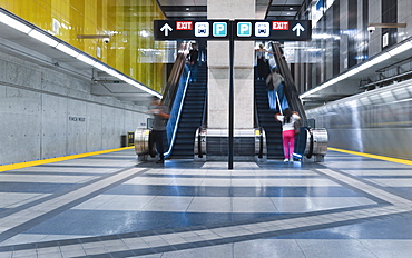 Interior train leaving the Finch West subway station on the Yonge-University line, passengers on an escalator, Toronto, Ontario, Canada