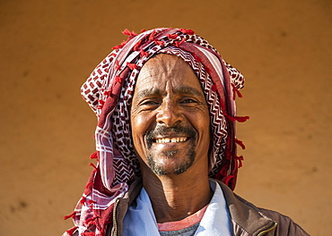 Portrait of an Eritrean man smiling with a headscarf on his head, Monday livestock market, Keren, Anseba Region, Eritrea