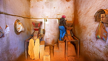 Woman working on a red pepper mill at the Medeber Market, Asmara, Central Region, Eritrea