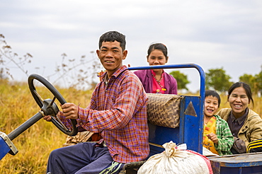 Family riding together in truck through farm fields, Taungyii, Shan State, Myanmar