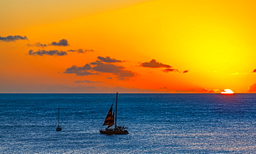 Sunset over the ocean with sailboats off Waikiki Beach, Honolulu, Oahu, Hawaii, United States of America