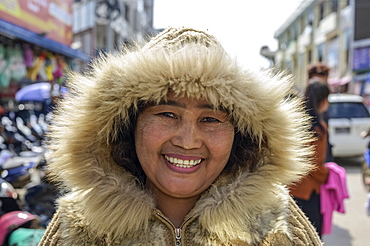 Woman wearing a warm, fur-trimmed coat at the market, Lashio, Shan State, Myanmar