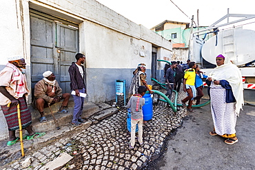 People by a water truck in Harar Jugol, the Fortified Historic Town, Harar, Harari Region, Ethiopia