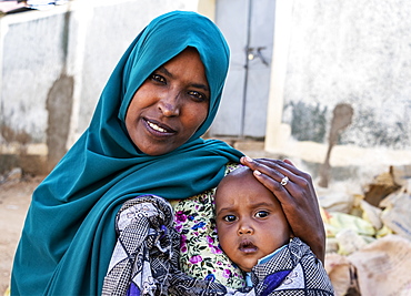 Ethiopian woman holding a boy in Harar Jugol, the Fortified Historic Town, Harar, Harari Region, Ethiopia