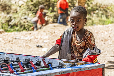 Ethiopian boy playing table football, Koka Reservoir (Lake Gelila), Oromia Region, Ethiopia