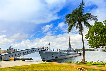 Torpedo display and tourists exploring a submarine at Pearl Harbour, Oahu, Hawaii, United States of America