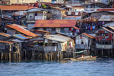 Poor district slums with wooden houses over water, Cebu city, Philippines