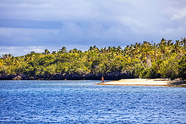 A young woman with snorkel gear alone on a beach, Cabilao Island, Central Visayas, Philippines