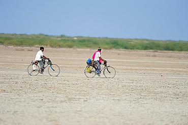 In rural India men go on bicycles to far off towns for work, Gujarat, India, Asia