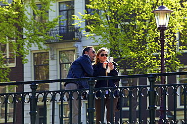 Tourists on Canal Bridge, Amsterdam, Netherlands, Europe