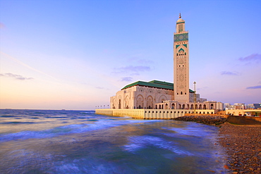 Exterior of Hassan ll Mosque and coastline at dusk, Casablanca, Morocco, North Africa, Africa