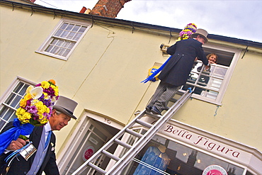 Tutti Man ascending ladder to receive a kiss, Tutti Day, traditional annual Hocktide Festival, Hungerford, Berkshire, England, United Kingdom, Europe