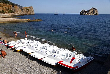 Pedal boats and rocks in sea, Crimea, Ukraine, Europe