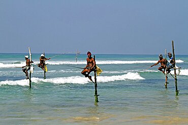 Stilt fishermen and Indian Ocean, Weligama, Sri Lanka, Asia