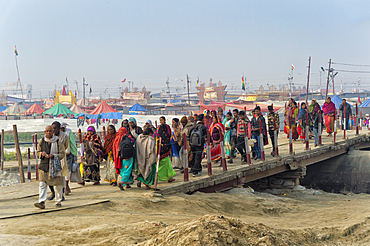 Pilgrims crossing the Ganges river on a temporary pontoon bridge, Allahabad Kumbh Mela, Allahabad, Uttar Pradesh, India, Asia