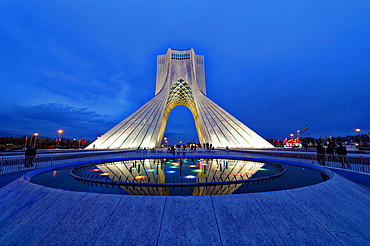 Azadi Tower (Freedom Monument) and cultural complex reflecting in a pond at sunset, Tehran, Islamic Republic of Iran, Middle East