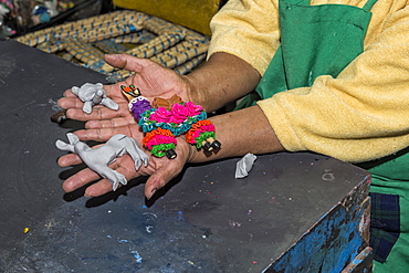 Woman presenting figurines made of masapan (bread dough), Calderon, Pichincha Province, Ecuador, South America 