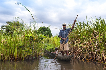 Malagasy man and his son in a small boat, Maroantsetra, Madagascar, Africa