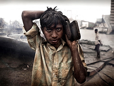 Shipbreakers #01.  EPOTY 2012 entry.  In Chittagong, Bangladesh, is the world's largest marine cemetery.    Hundreds of ships annually go to these shores, where a huge number of workers, day by day, working by hand scrapping these huge masses of metal, all without gloves, barefoot and without health insurance. 