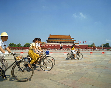 People cycling through Tiananmen Square outside the Forbidden City, Beijing, China, Asia