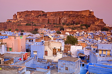 Elevated view over colorful houses of the Blue City towards Meherangarh Fort, Jodhpur, Western Rajasthan, India, Asia