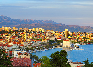 Elevated view over Split's picturesque Stari Grad and harbour illuminated at sunset, Split, Dalmatia, Croatia, Europe