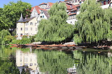 Holderlinturm tower and Stocherkahn (punt) reflecting in Neckar River, Tubingen, Baden Wurttemberg, Germany