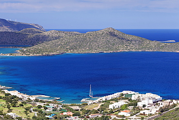 Coast and resort of Elounda, Spinalonga Island, Gulf of Mirabello, Crete, Greek Islands, Greece, Europe