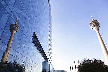 Rheinturm tower reflecting in the facade of Stadttor building, Dusseldorf, North Rhine-Westphalia, Germany, Europe 