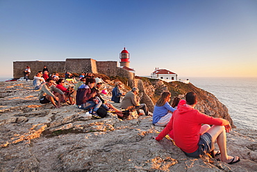 Tourists enjoying sunset at the lighthouse at Cabo de Sao Vicente, Sagres, Algarve, Portugal, Europe