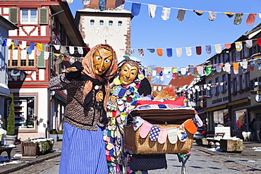 Couple in traditional costumes of Witch and Spattleshansel with a buggy, Swabian Alemannic Carnival, Gengenbach, Black Forest, Baden Wurttemberg, Germany, Europe