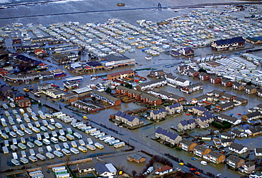 The flooded town of Towyn in North Wales. Caravans in a mobile home park and caught up in the disaster.  Streets of houses are surrounded by the flood waters.