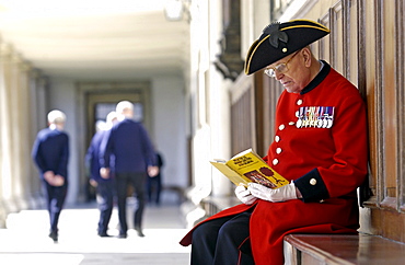 A Chelsea pensioner sitting outside the Royal Hospital Chelsea, London